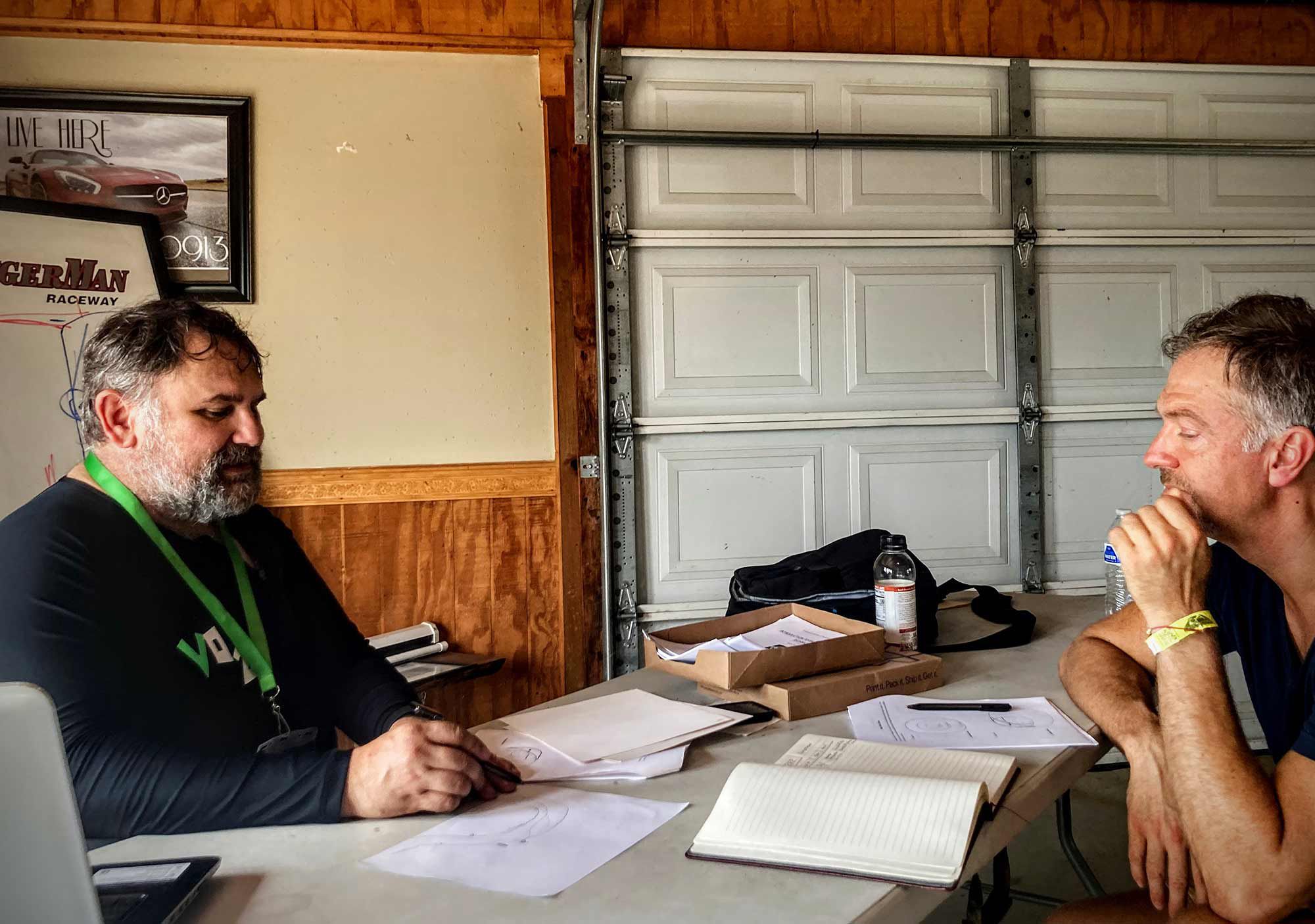 Of course class is held in a garage. Mark (left) going through track techniques with student Adam Mashike (right).